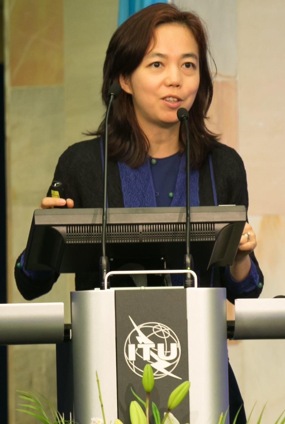 Fei-Fei Li speaking at an ITU lectern at AI for Good in 2017