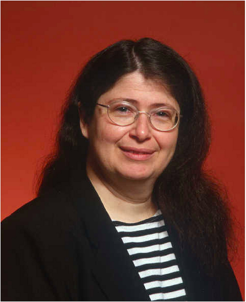 Portrait of Radia Perlman wearing glasses and a striped shirt